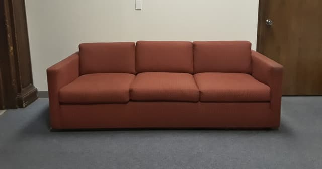 Rust red three seat sofa with track arms