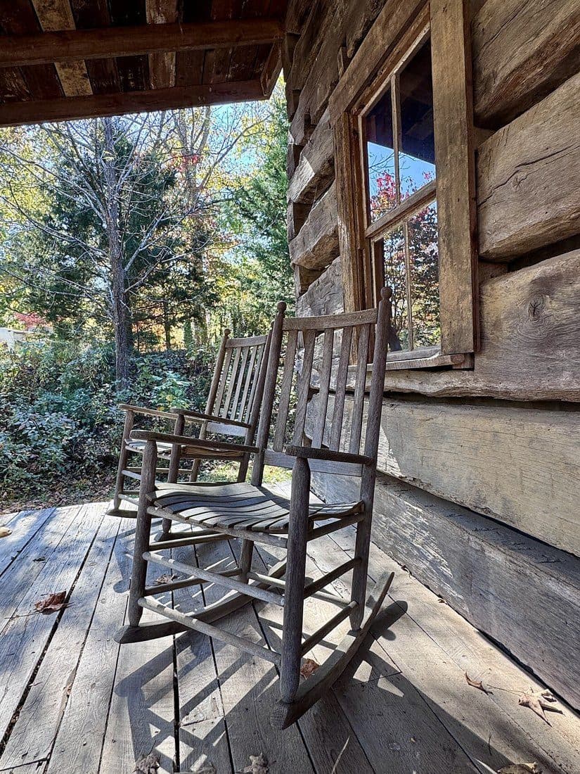 Two weathered wooden porch rocking chairs